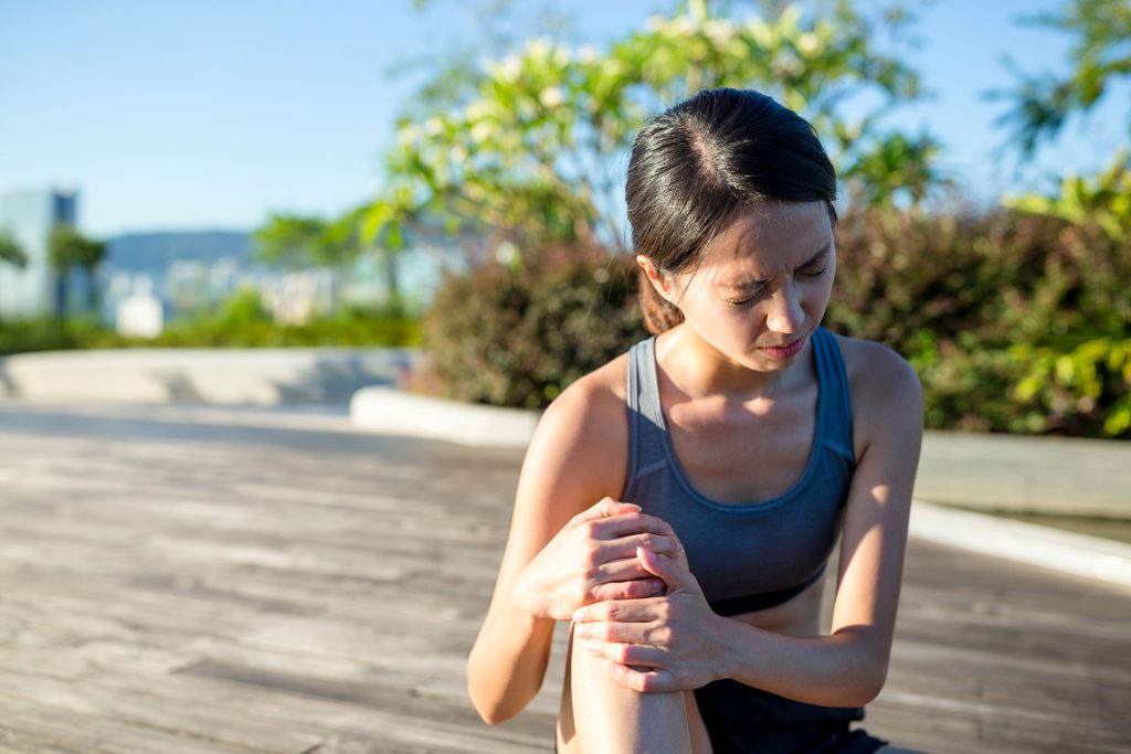 Woman in need of softwave therapy for joint pain.