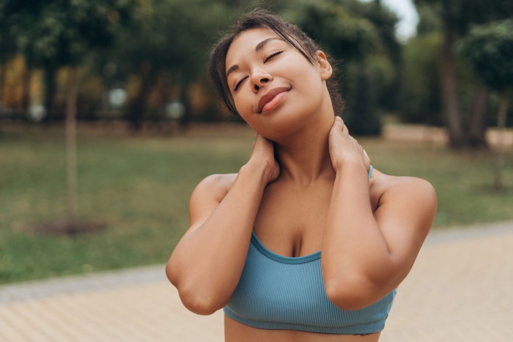 Smiling fit woman warming up for a jog.