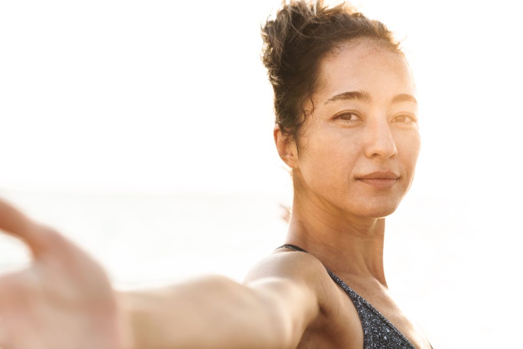 Young woman doing stretching outdoors.