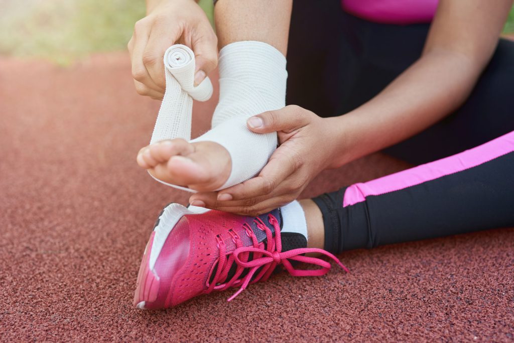 Woman putting bondage in her injured feet.
