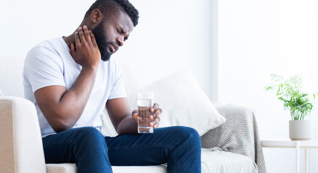 Handsome african-american man with neck pain.